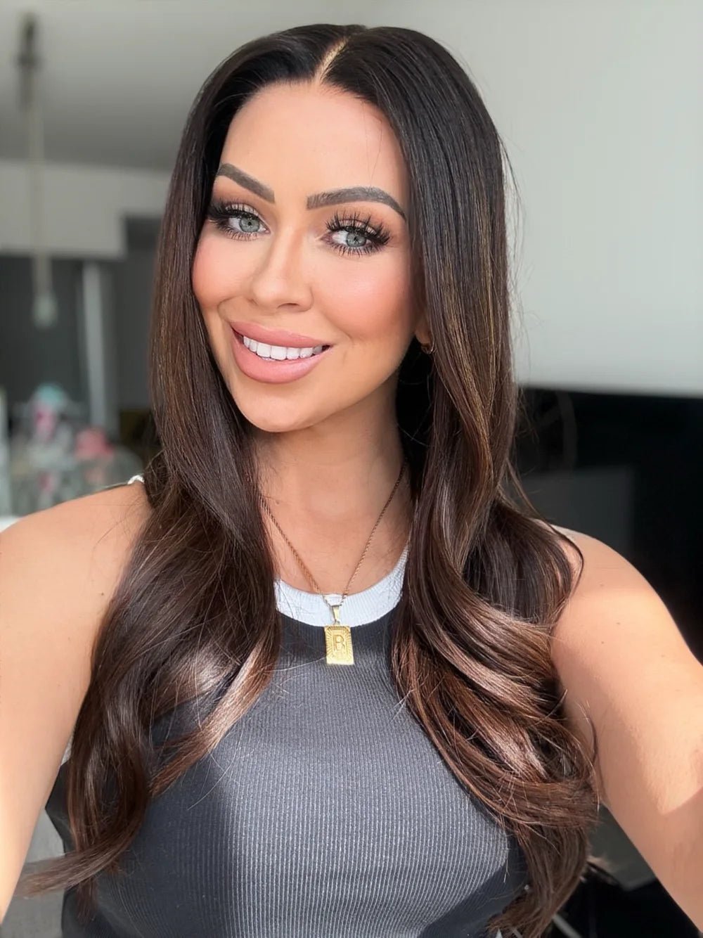 Woman wearing a polished brunette human-hair wig with natural parting and movement